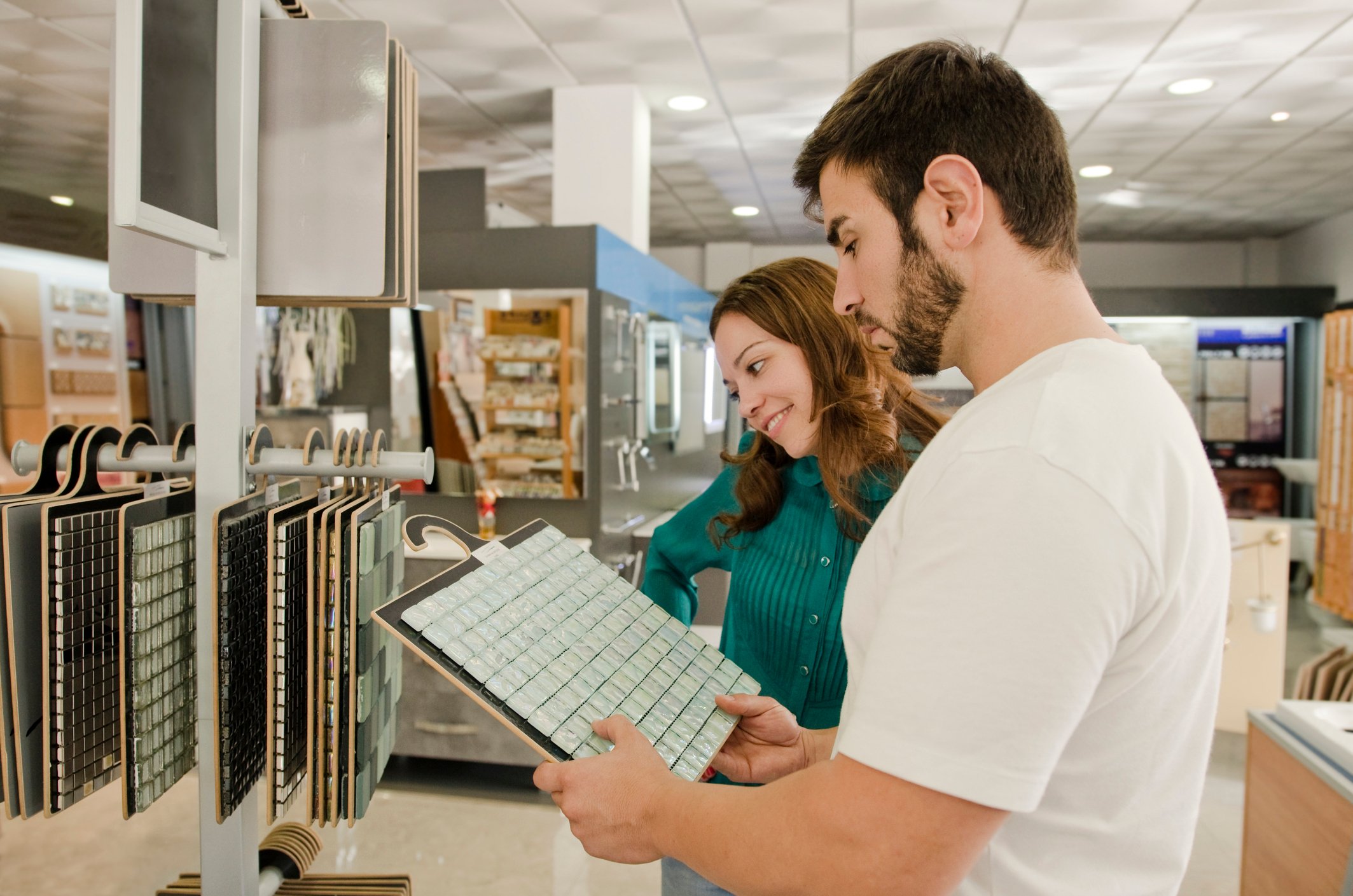 Two people looking at tile inside a home improvement store.