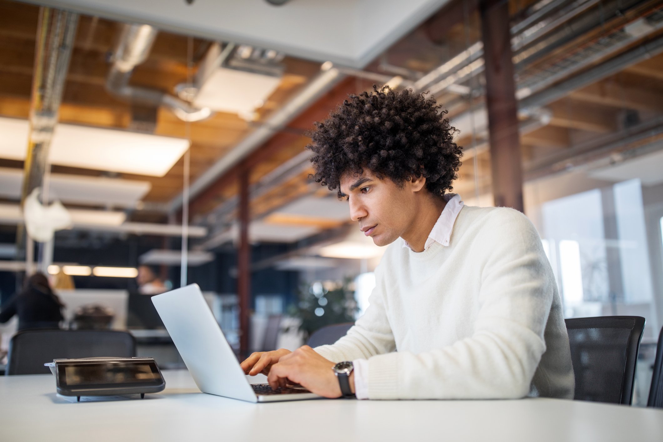 person sitting at a desk working on a computer