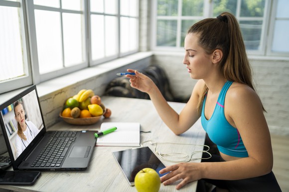 Person consulting with a physician during a virtual appointment.