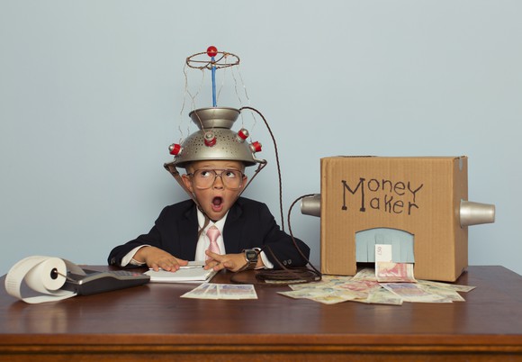 A child hooks up to a homemade "money maker" machine.