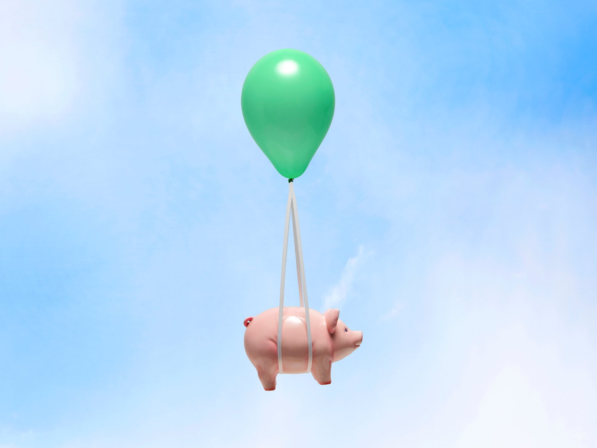 Pig attached to balloon flying through air.