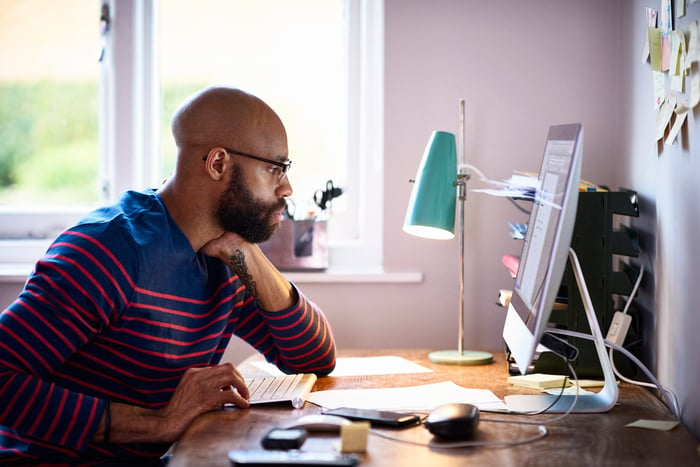 Person staring at computer screen.