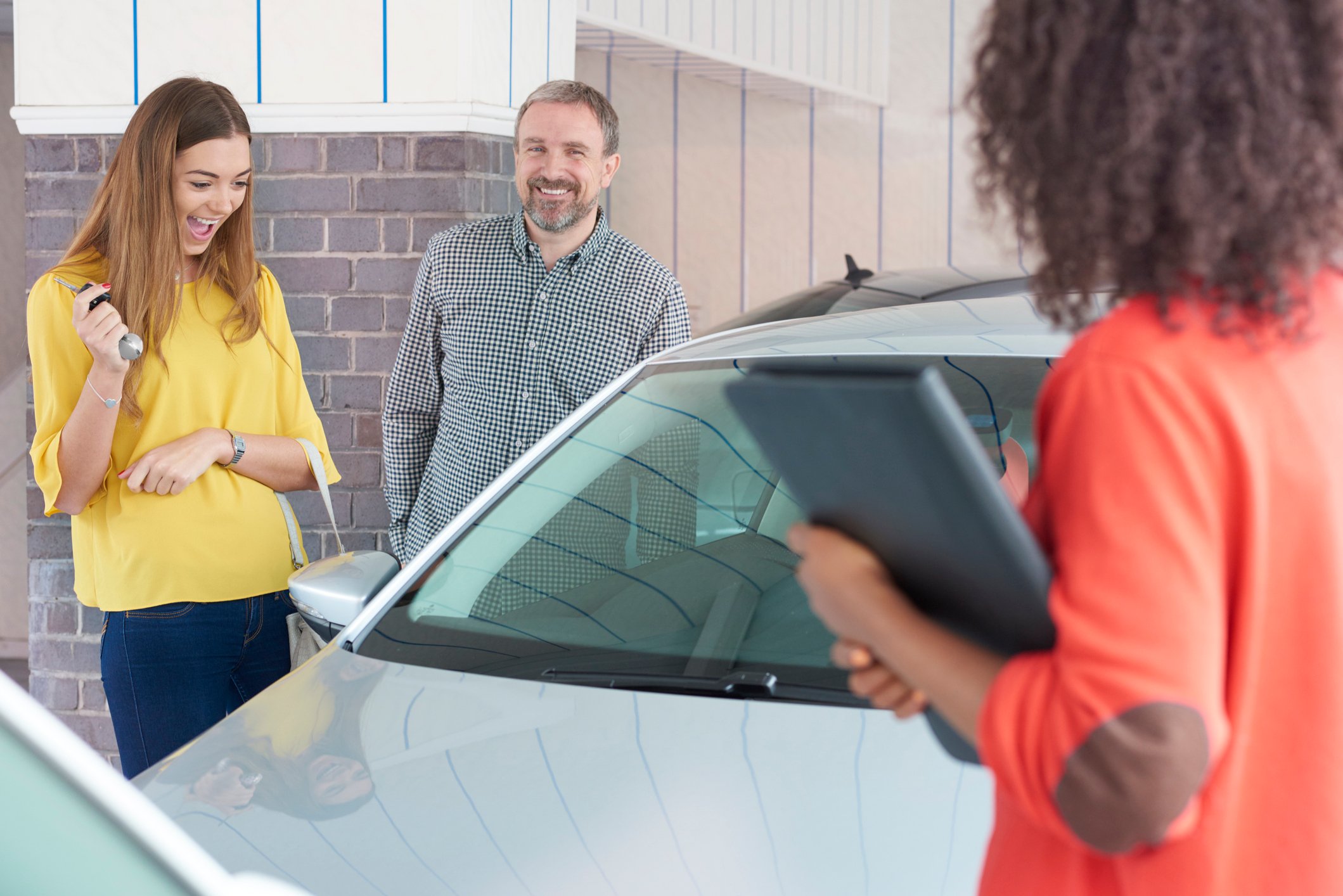 A father and daughter shopping for a used car together.