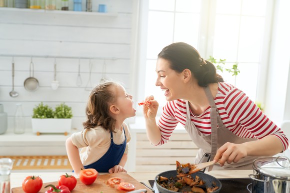 A mother and daughter cooking together.