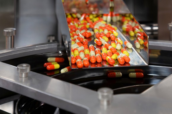Drug capsules being manufactured. 