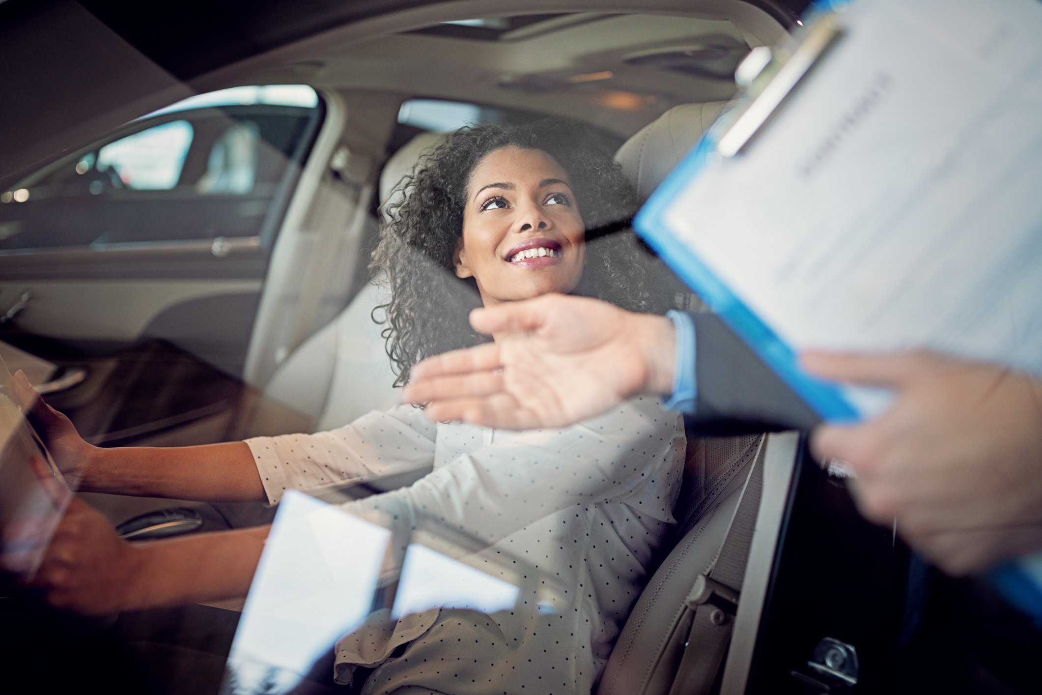 Woman happy buying an electric car. 