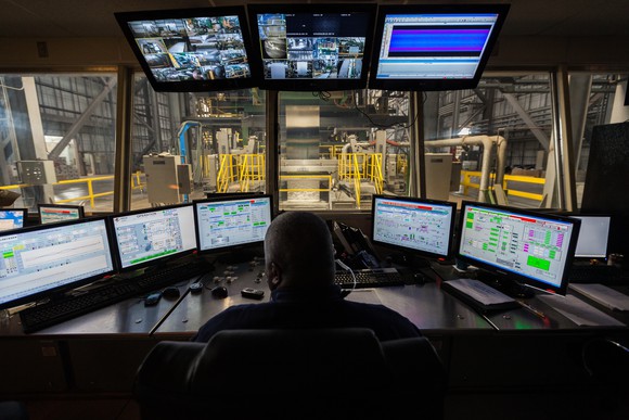 Nucor galvanizing line processing pulpit with computers and operator facing line.