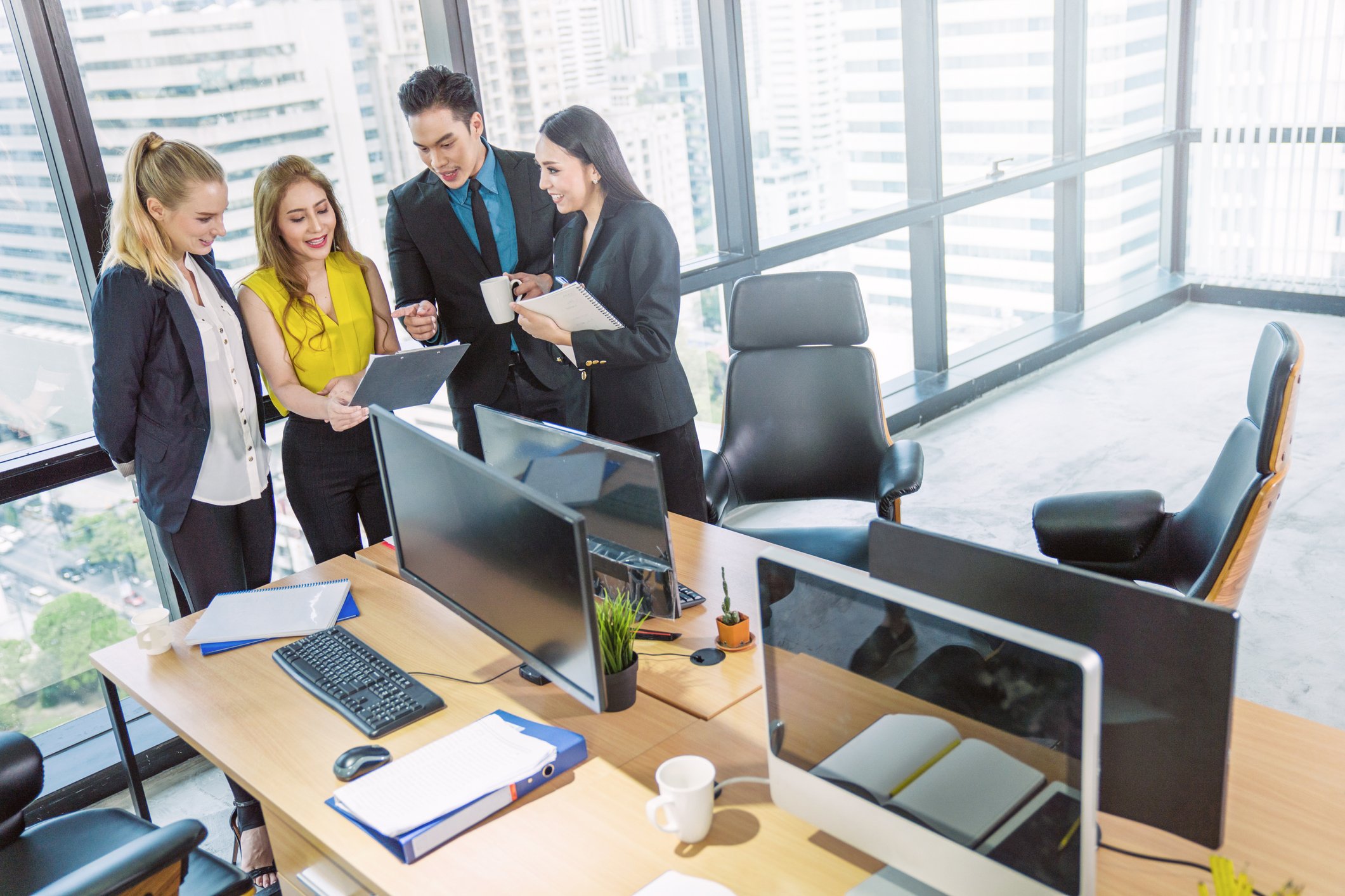 A group of investors working together in high rise office.