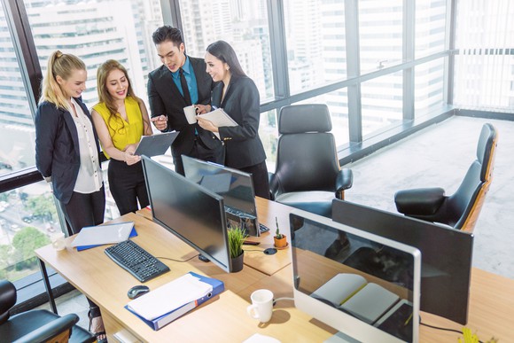 A group of investors working together in high rise office.