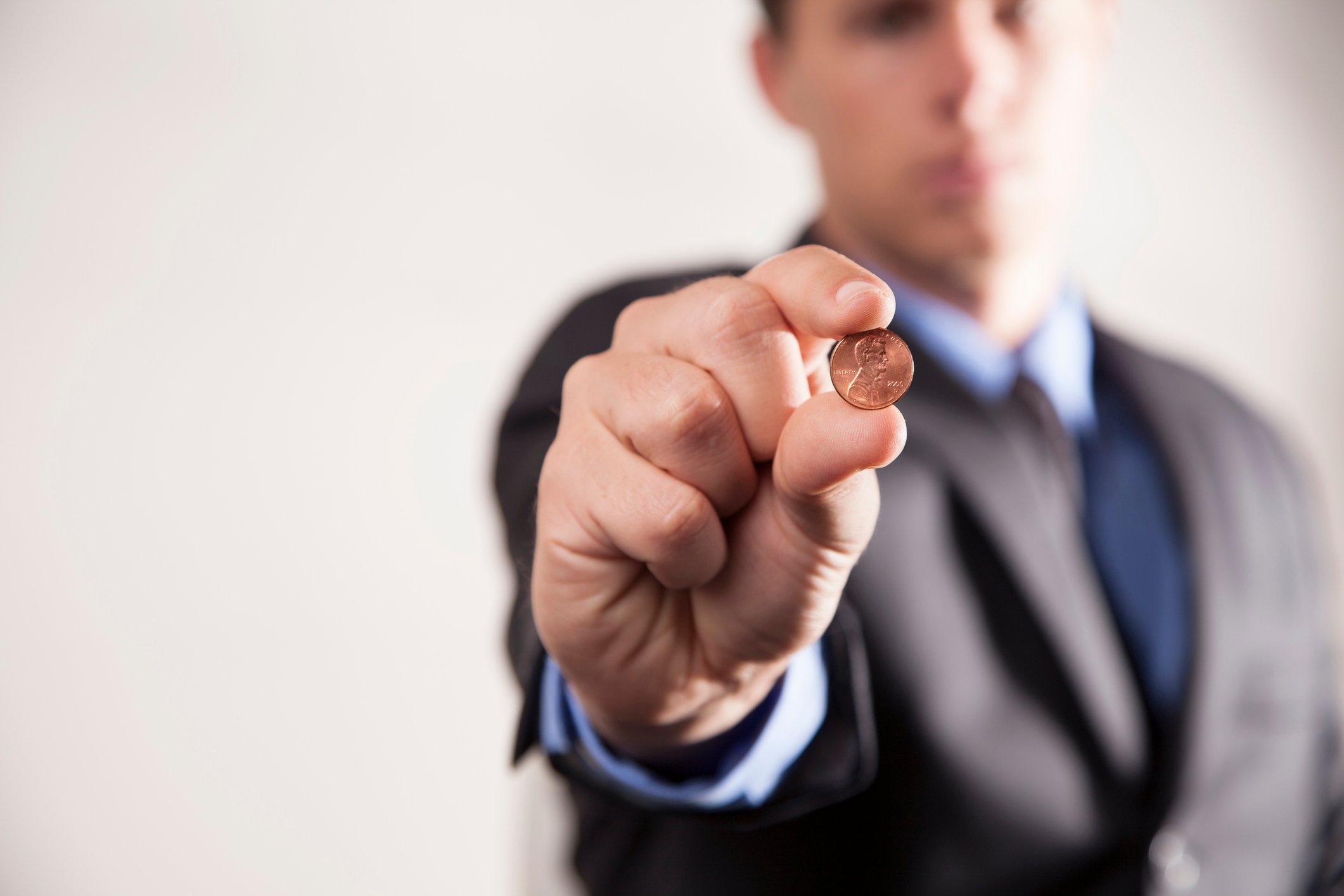 A person holding a penny.
