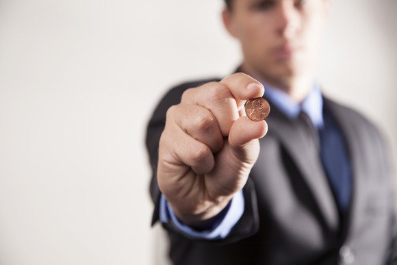 A person holding a penny.