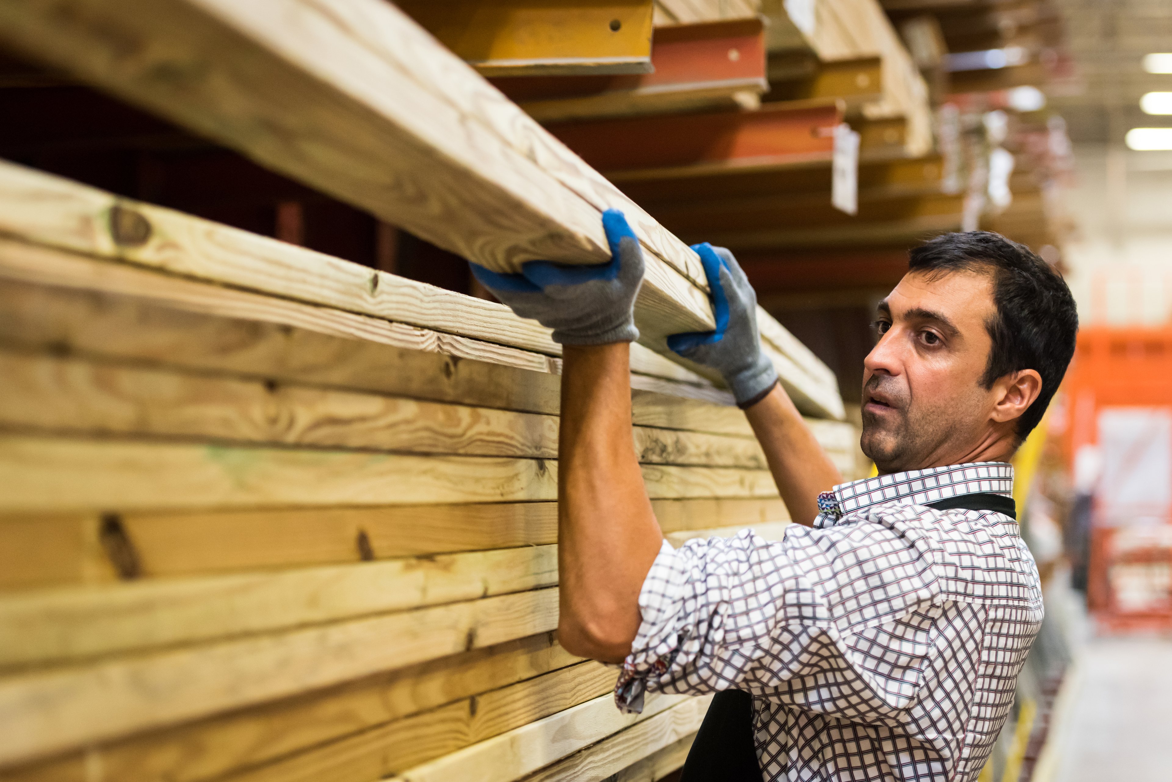Man stacking lumber at store