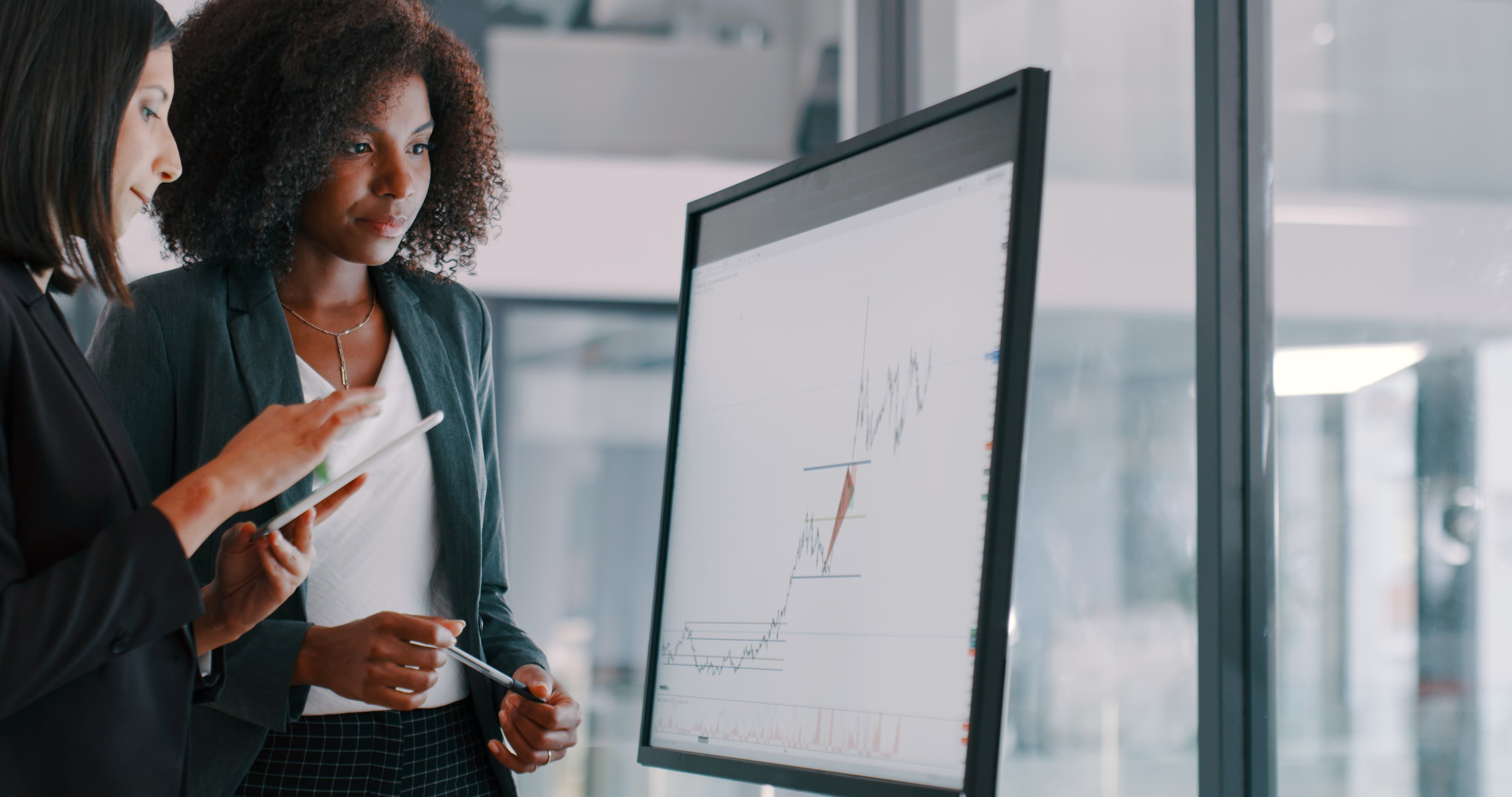 Two people looking at a graph.