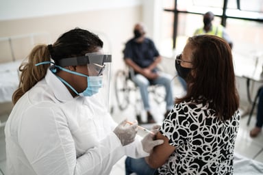 nurse vaccinates senior citizen