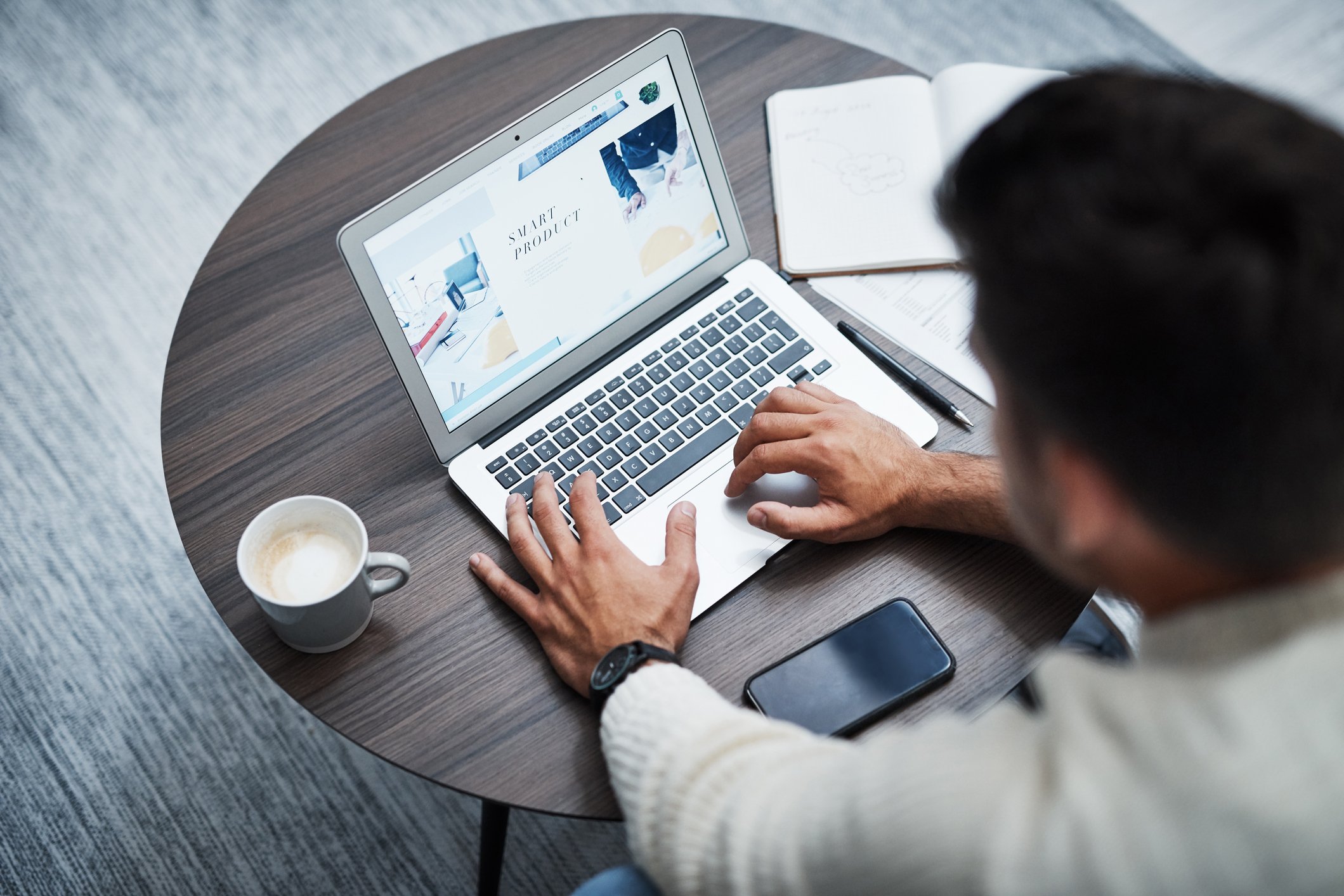 A person building a website on their laptop.