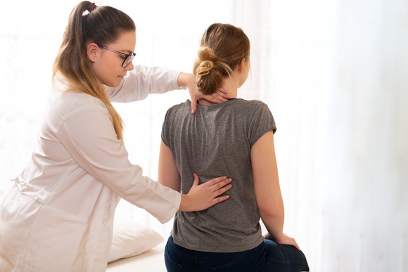 chiropractor performing adjustment on patient