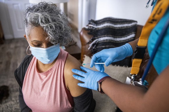A patient getting a vaccine in a clinic.