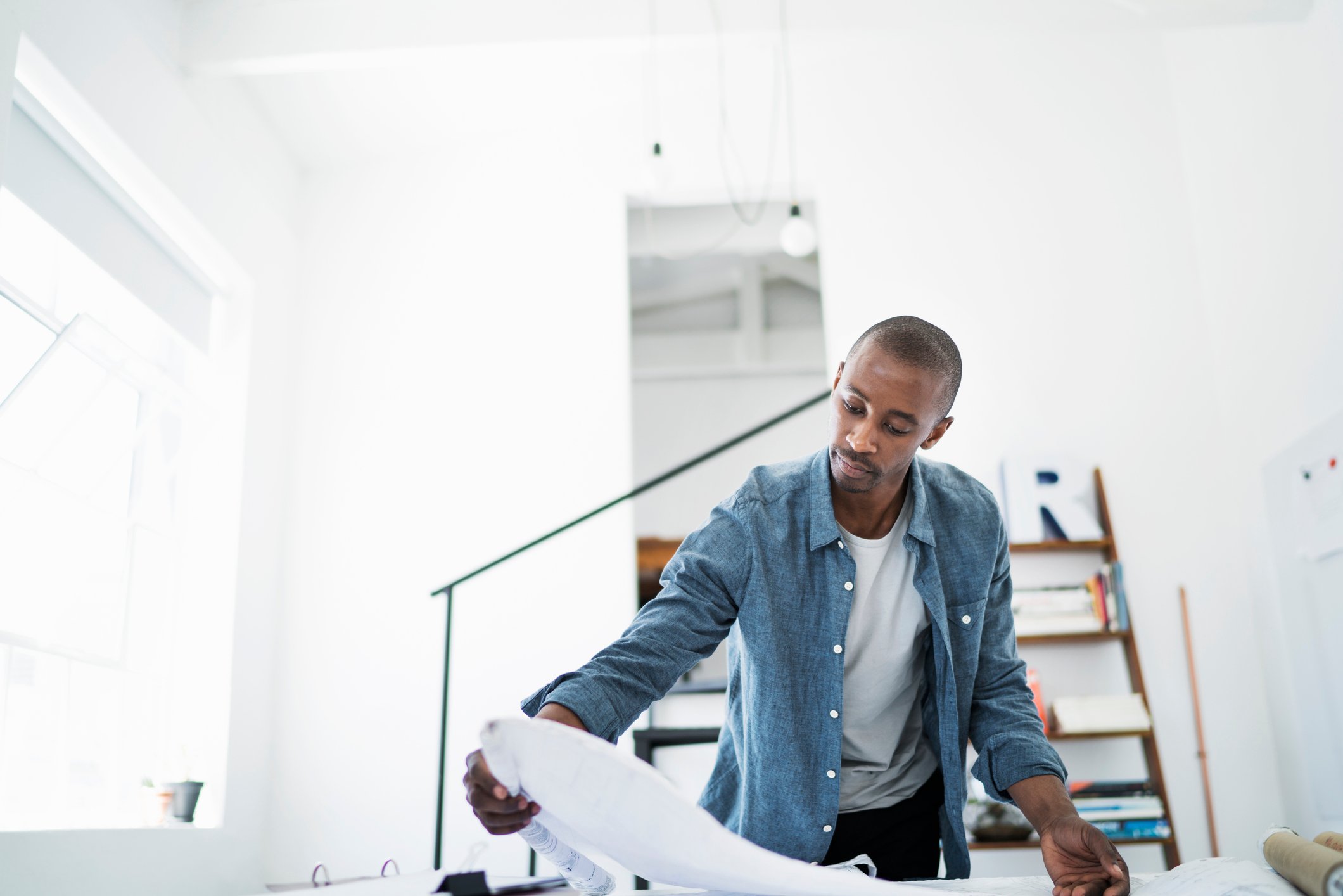 Man looking over some architectural designs.