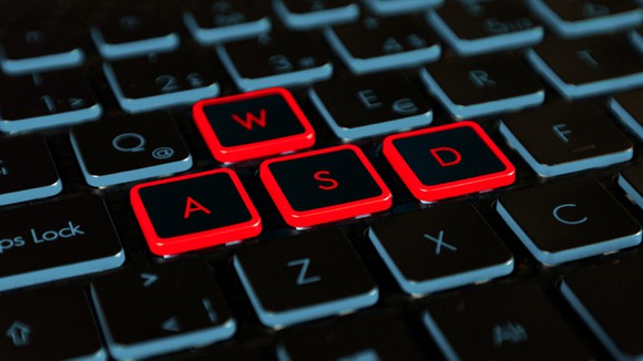 Close-up photo of a gaming keyboard, highighting the red WASD keys.