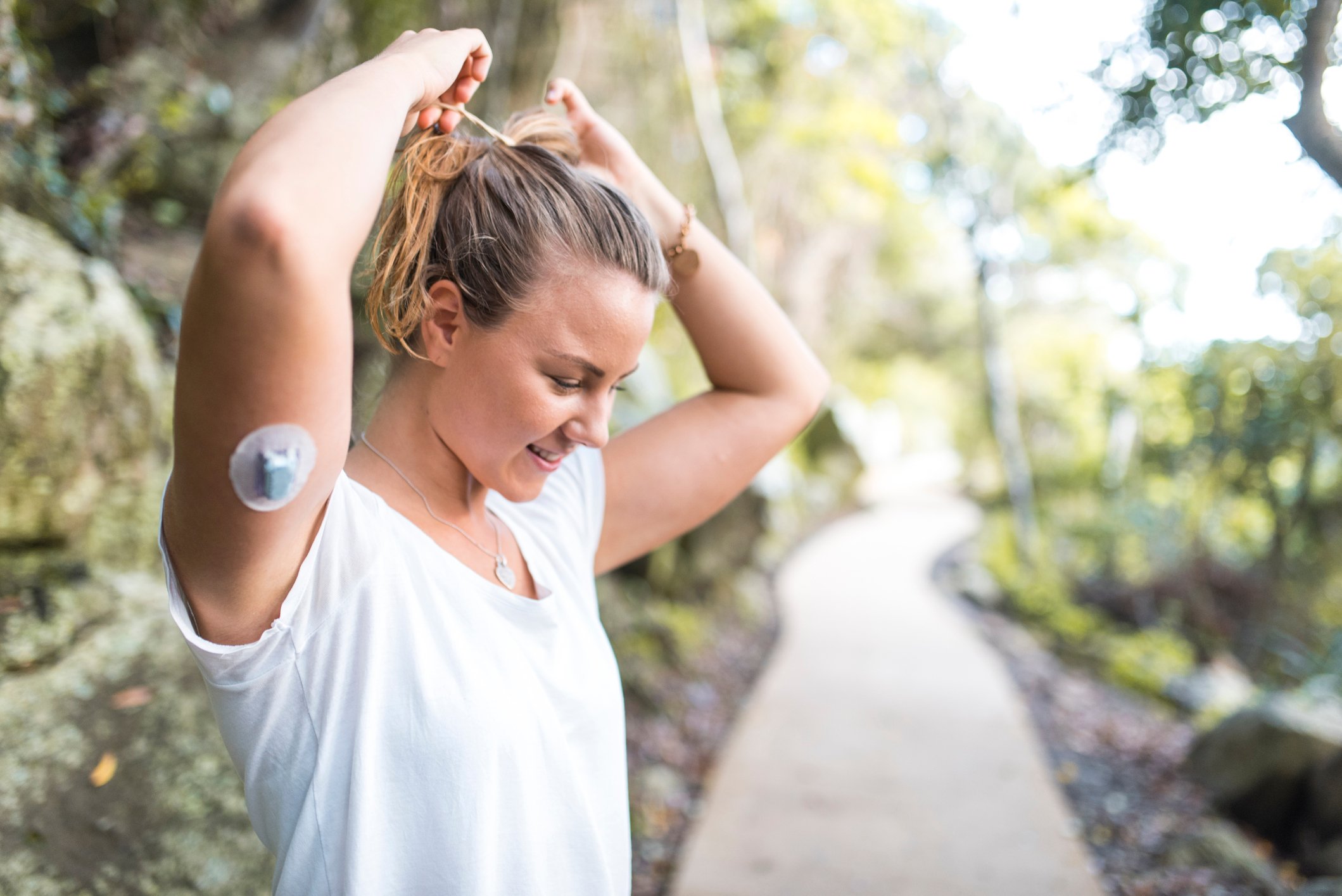 diabetic person exercising and wearing continuous glucose monitoring device