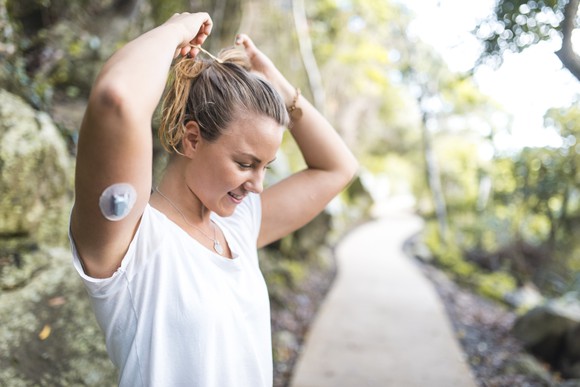 diabetic person exercising and wearing continuous glucose monitoring device