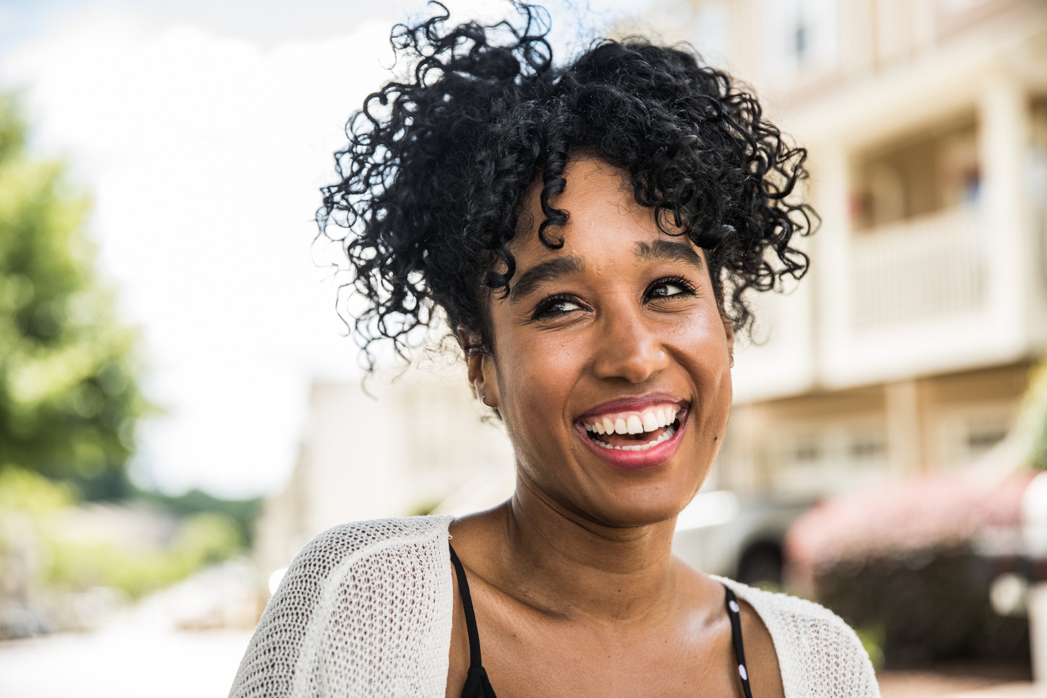 Young woman with excellent teeth smiling happily.