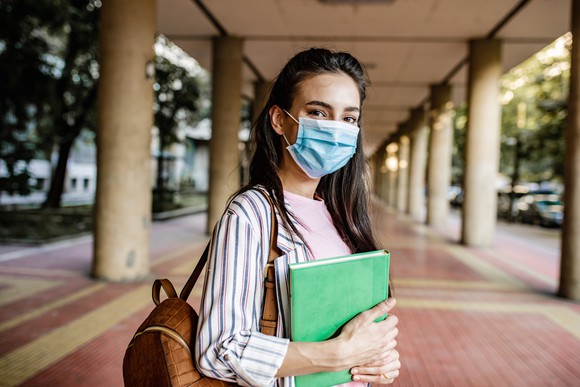 College student in outdoor hallway on campus.