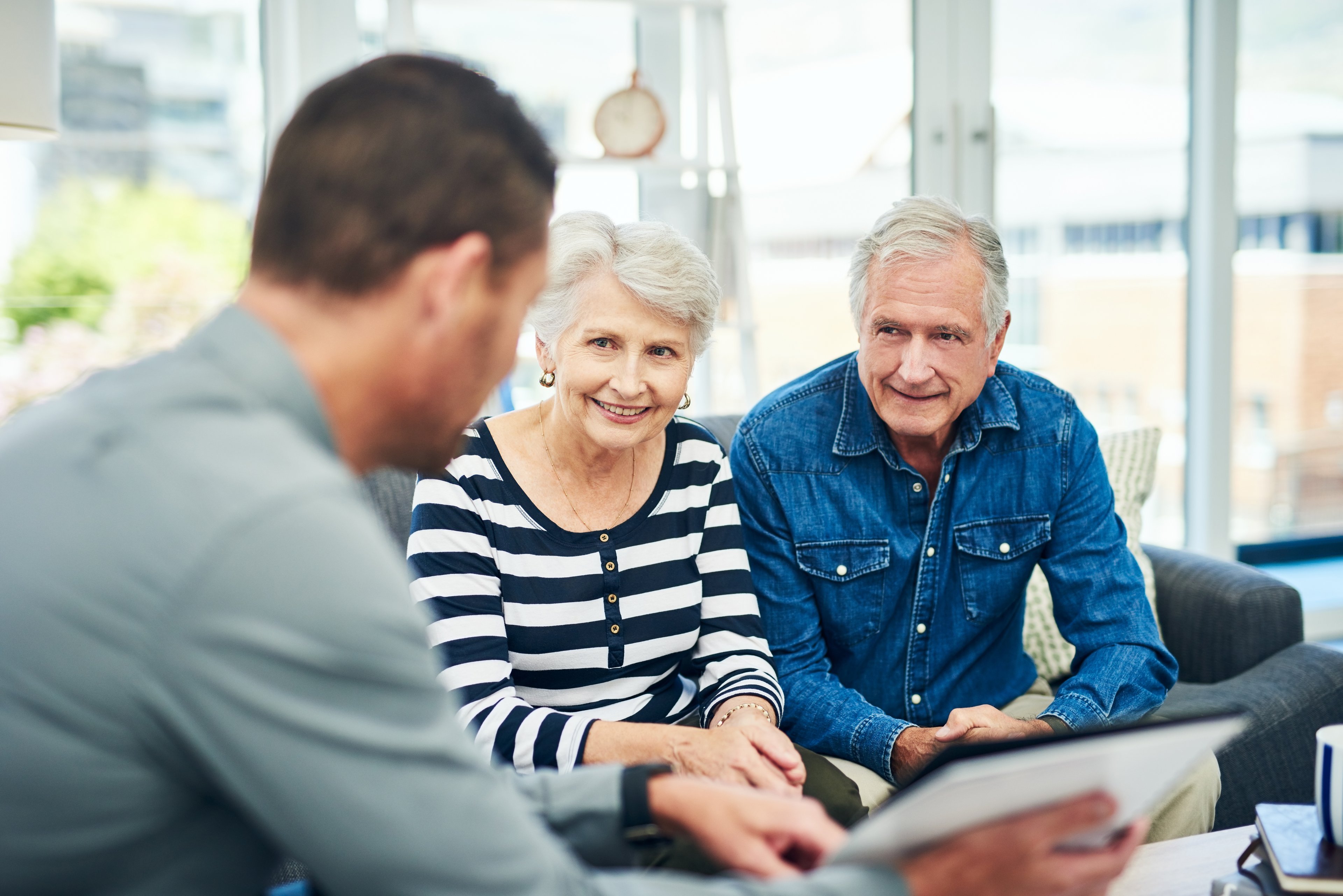 Elderly couple meeting with financial advisor.