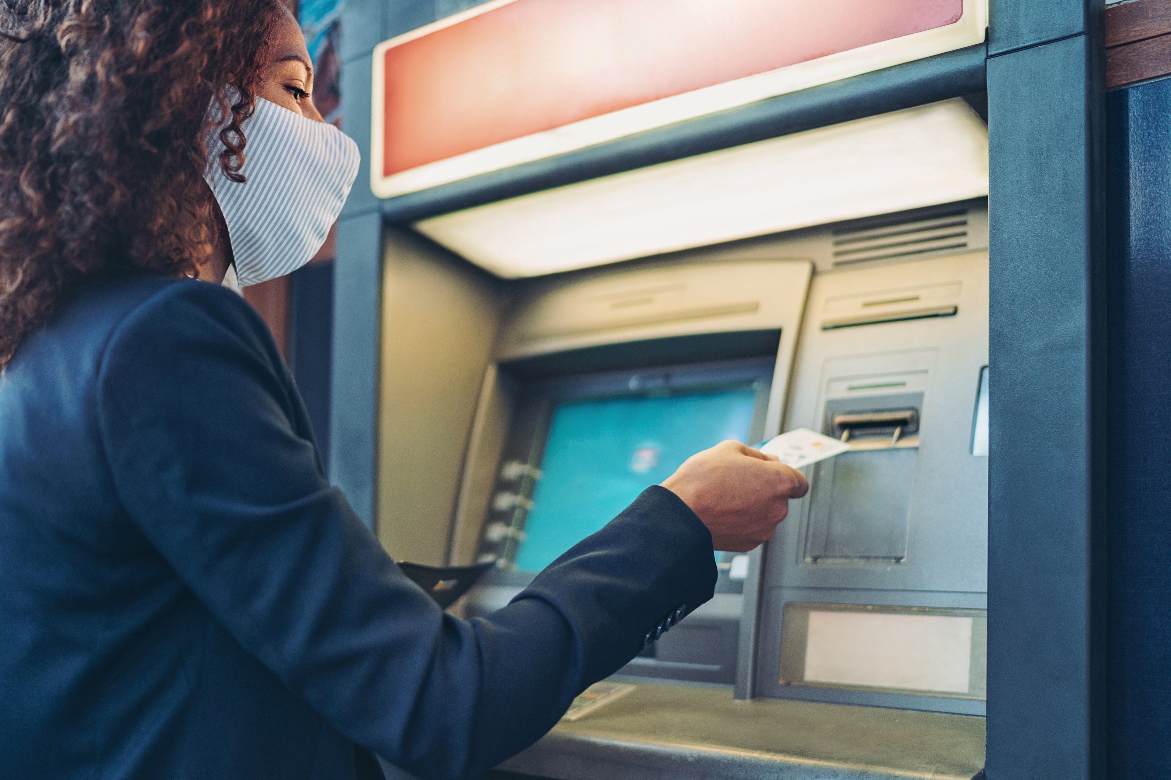 Woman withdrawing cash from an ATM.