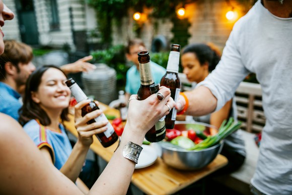 Friends drinking beer outdoors.