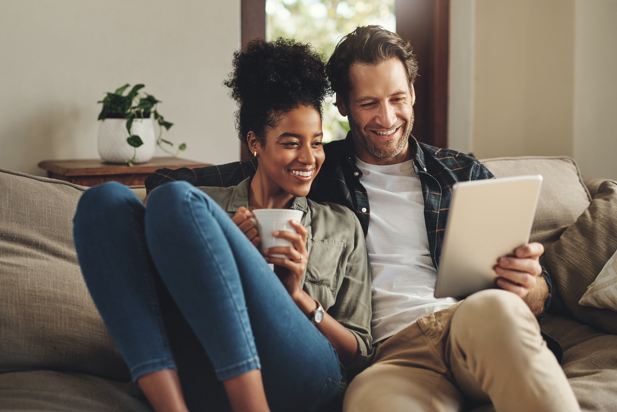Couple on couch browsing online.