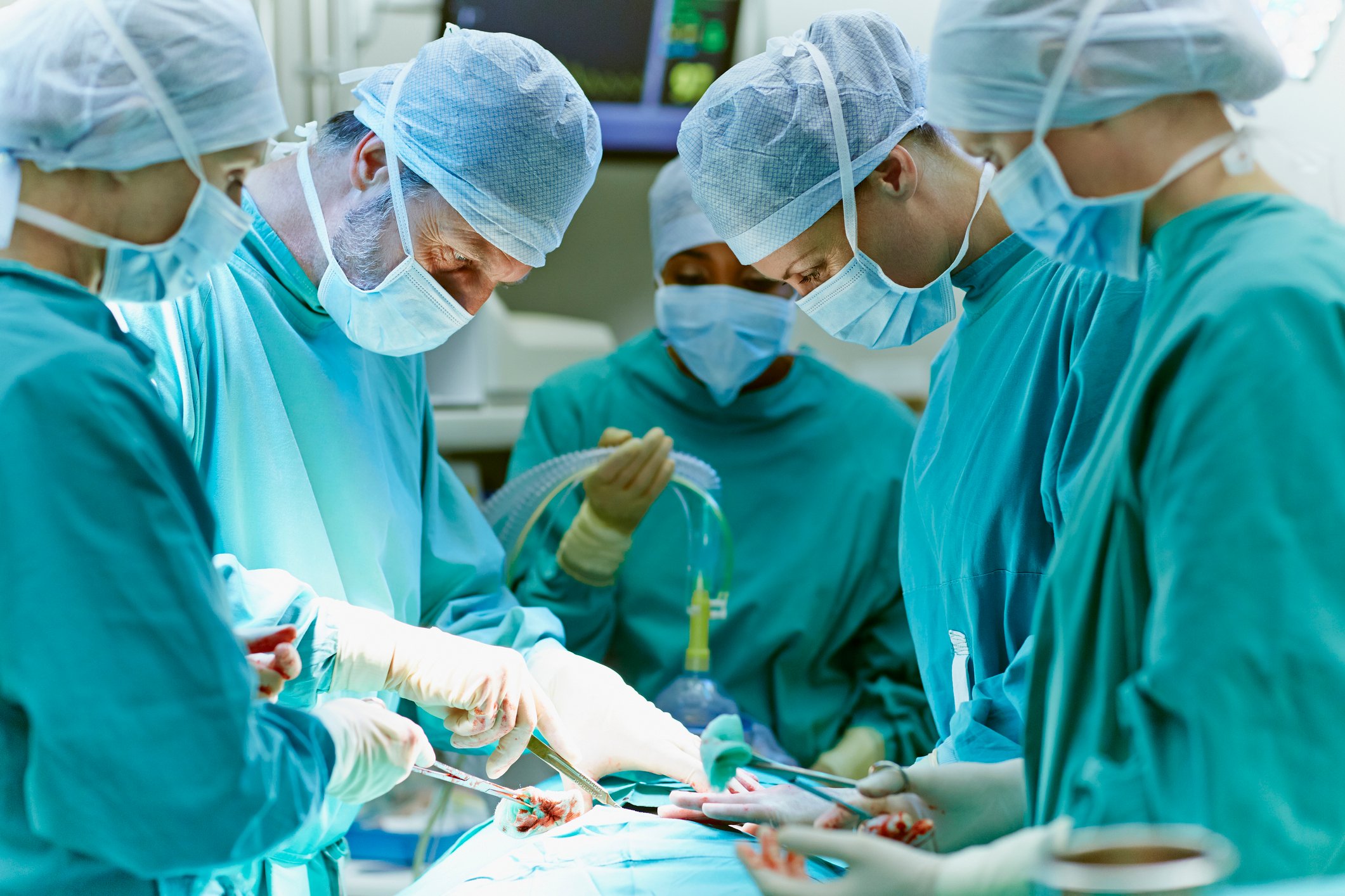 A surgical team performs surgery on a patient.