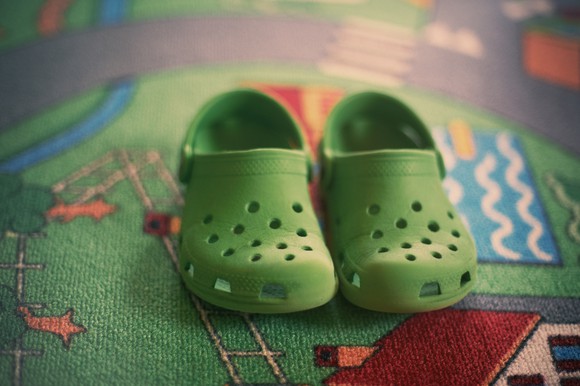 Pair of green foam clogs.