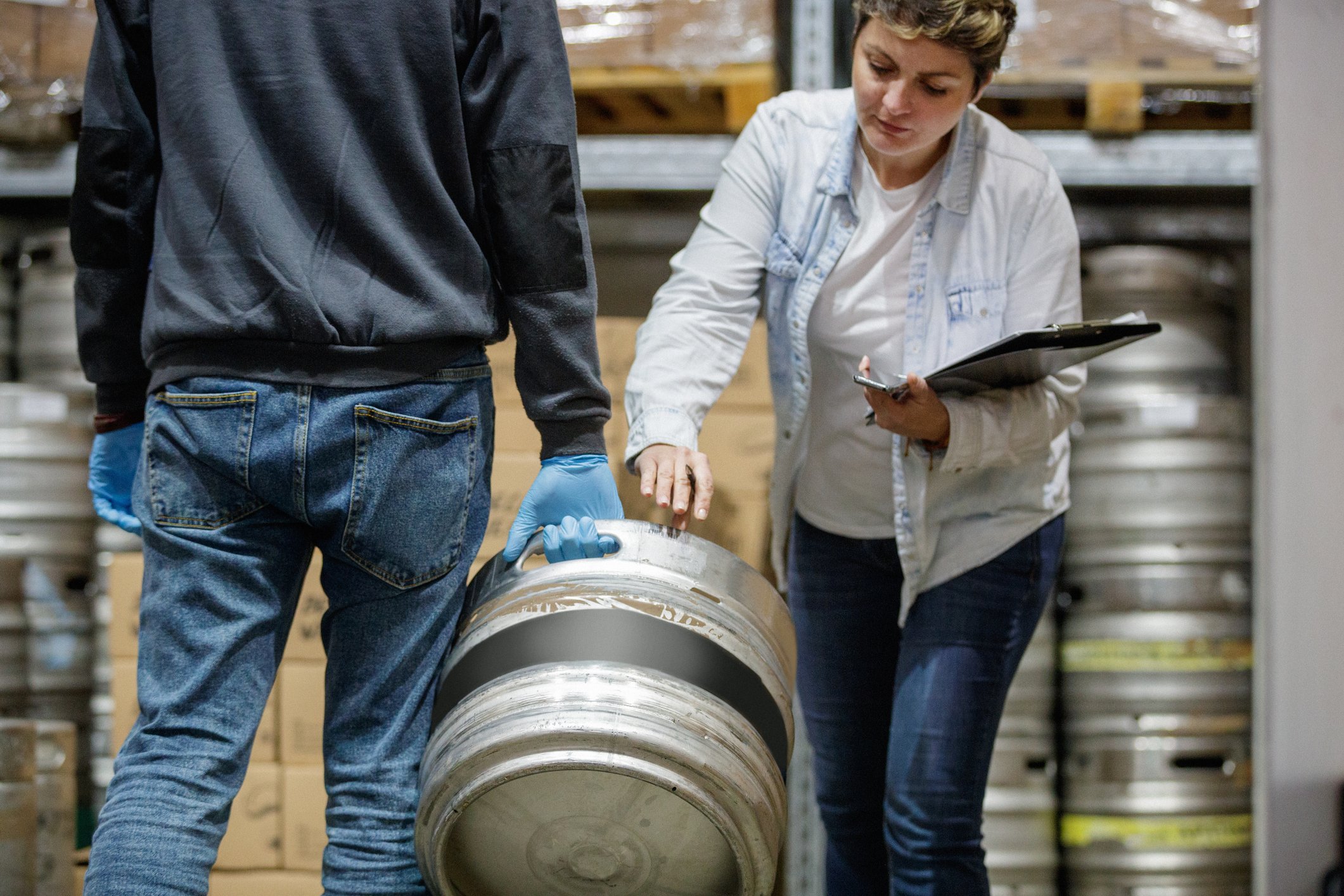 Woman checking in a keg 