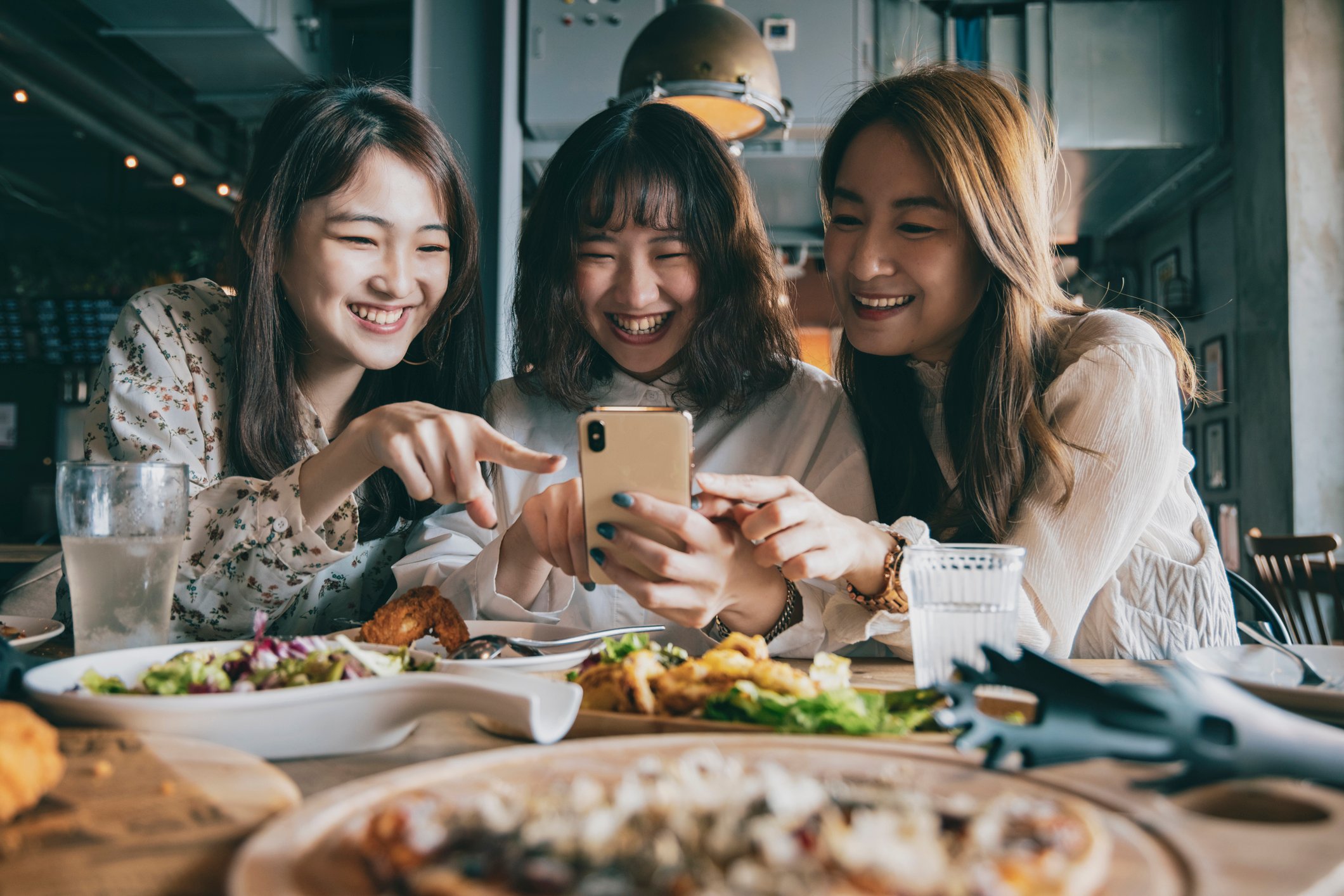 Three friends dining at a restaurant.