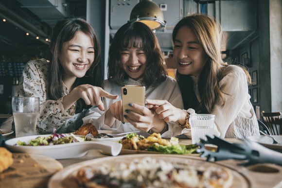 Three friends dining at a restaurant.