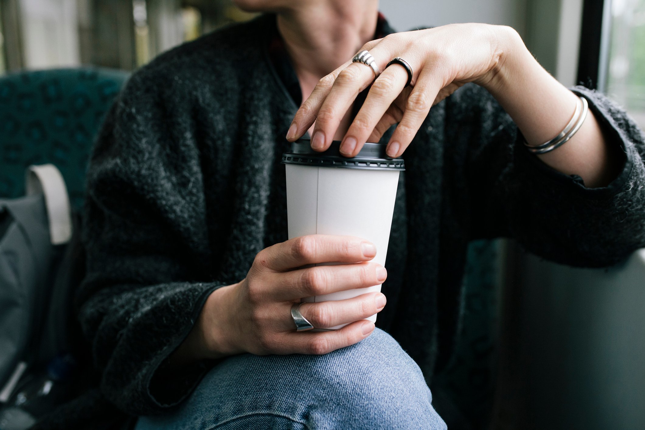 Person holding a cup of coffee.