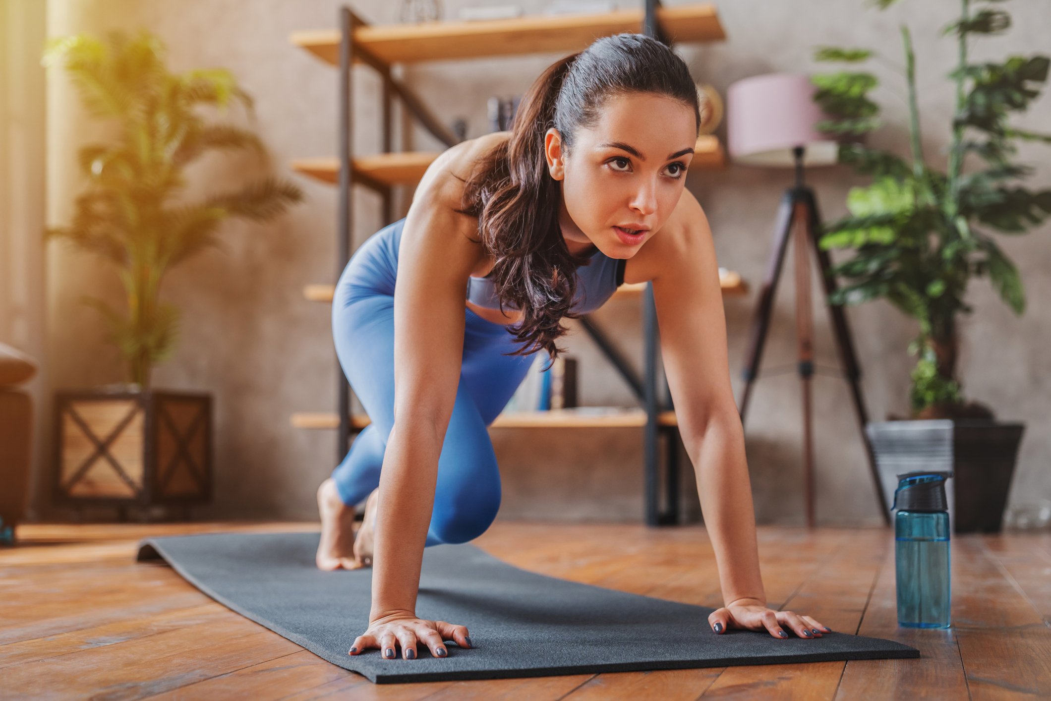 Person working out on a mat at home.