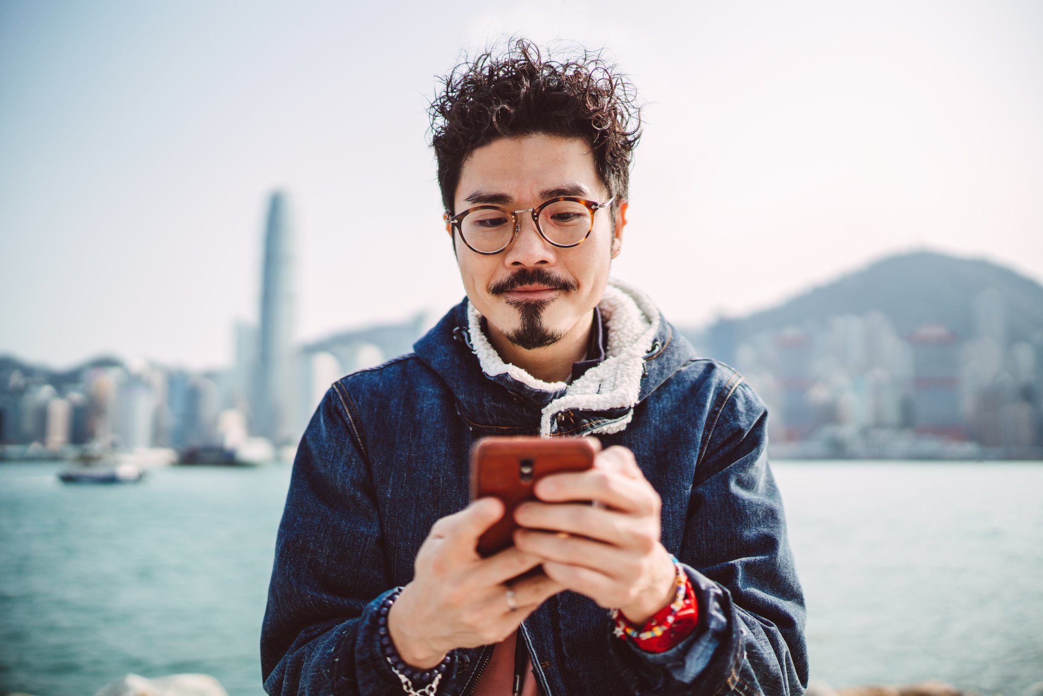 A smartphone user types a message.