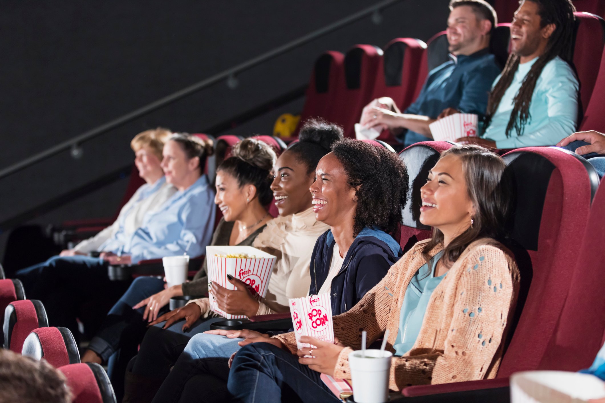 A group of people watching a movie in a movie theater.