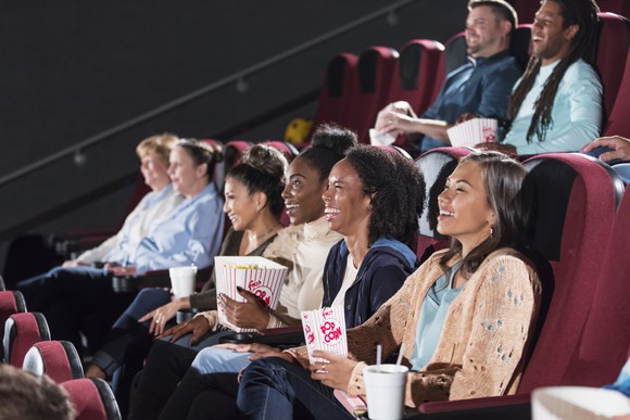 A group of people watching a movie in a movie theater.
