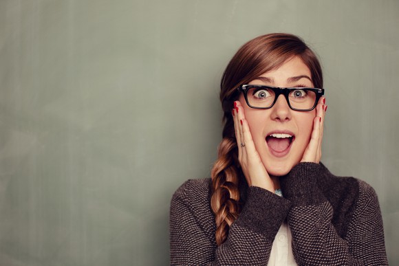 A surprised person with both hands on their face.