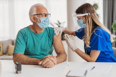 man getting a vaccine from a doctor