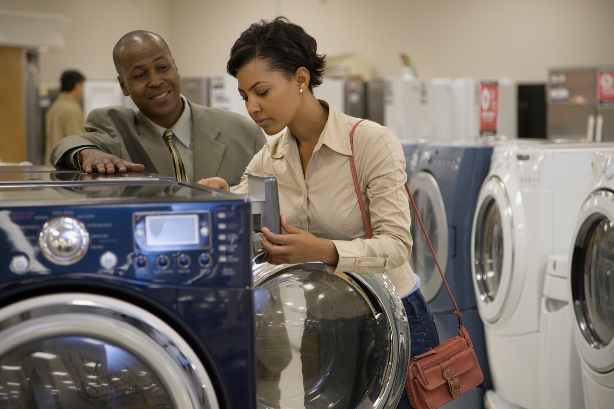 Two people shopping for a washing machine.