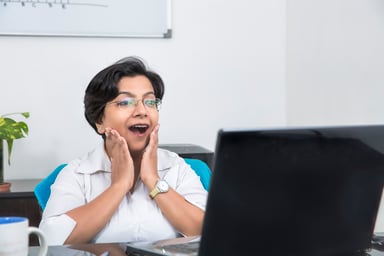 surprised investor hands on face look at computer