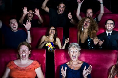 people cheering in a movie theater