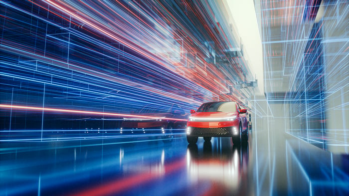 High-tech car speeding through blurred lines of light.