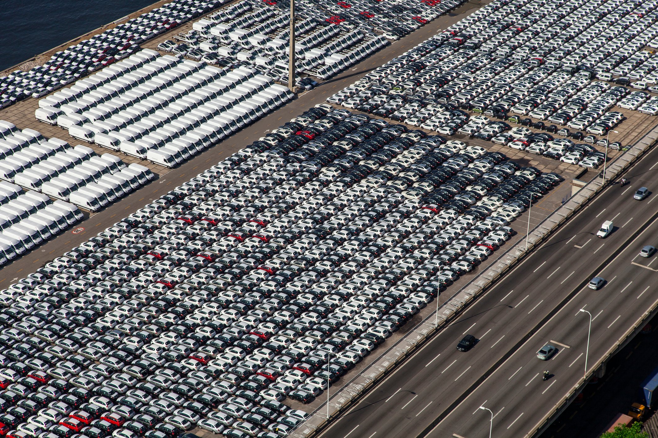 An aerial view of cars and trucks parked after manufacture, awaiting shipment. 