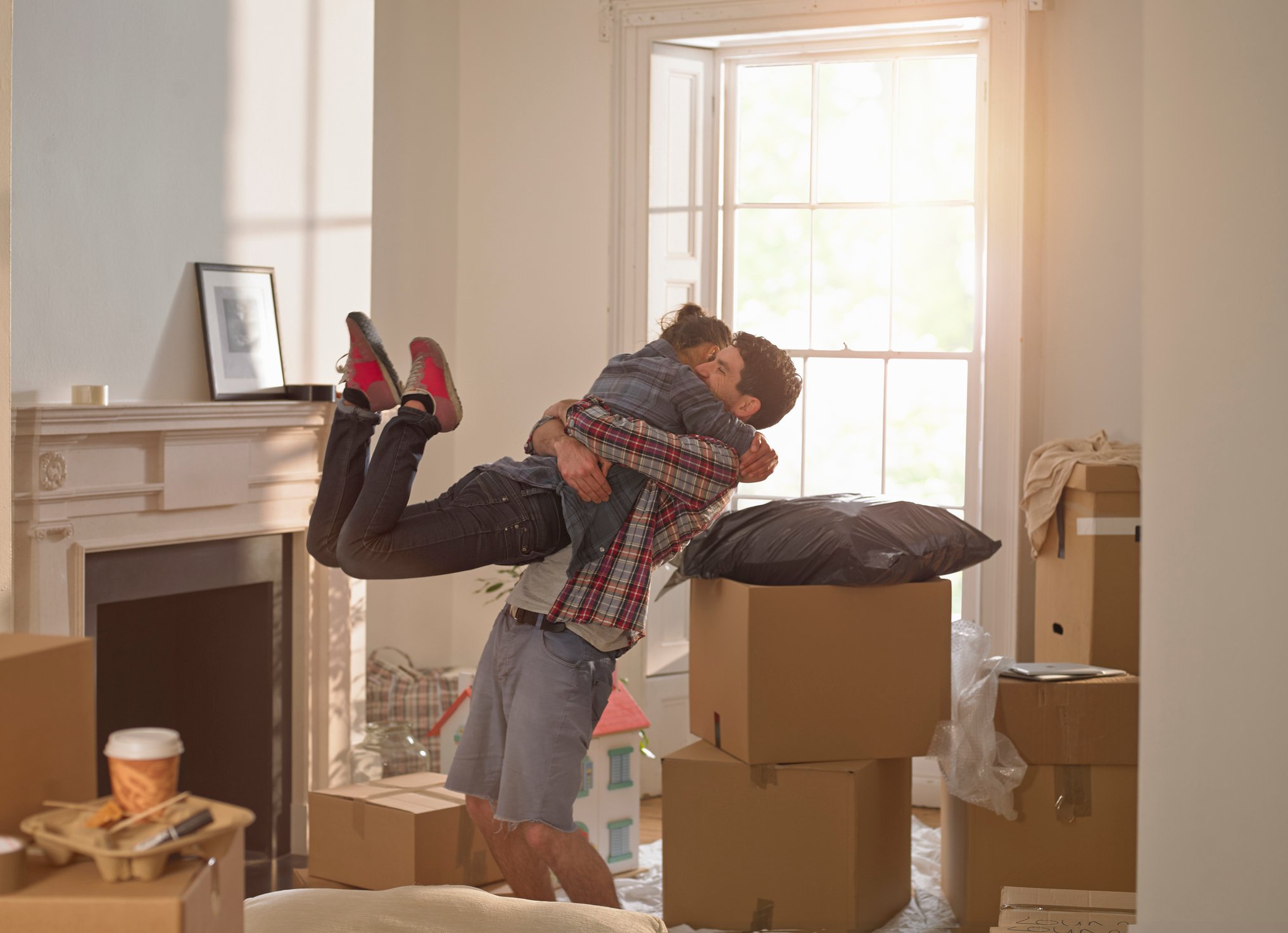 Couple embracing after moving into a new house.