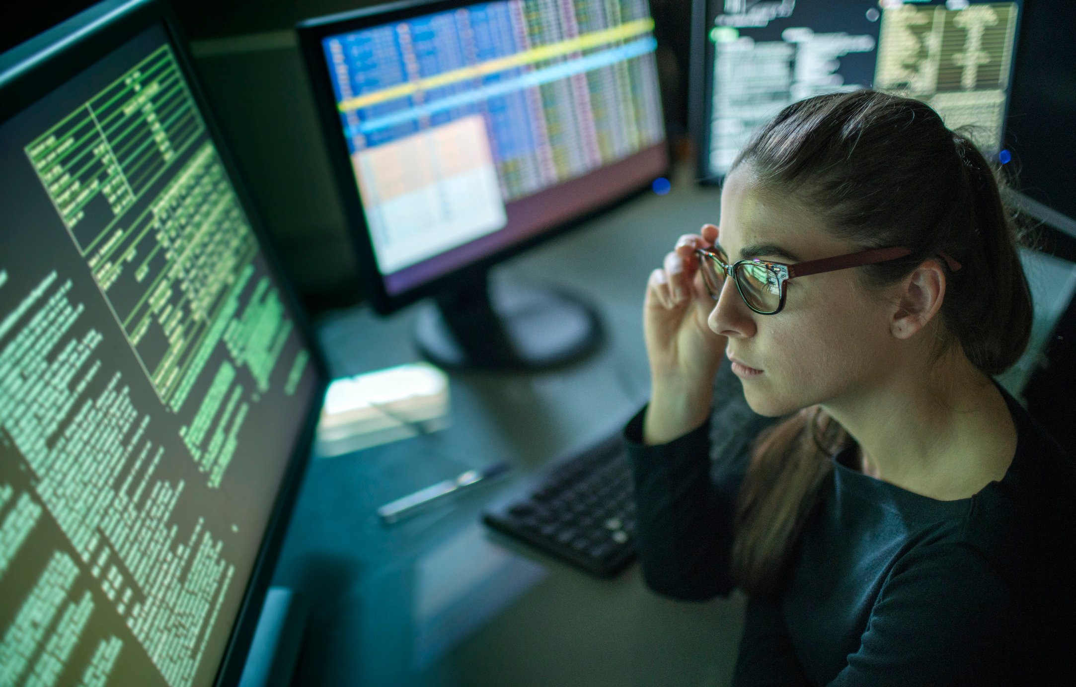 An office worker looks at data on a computer screen.